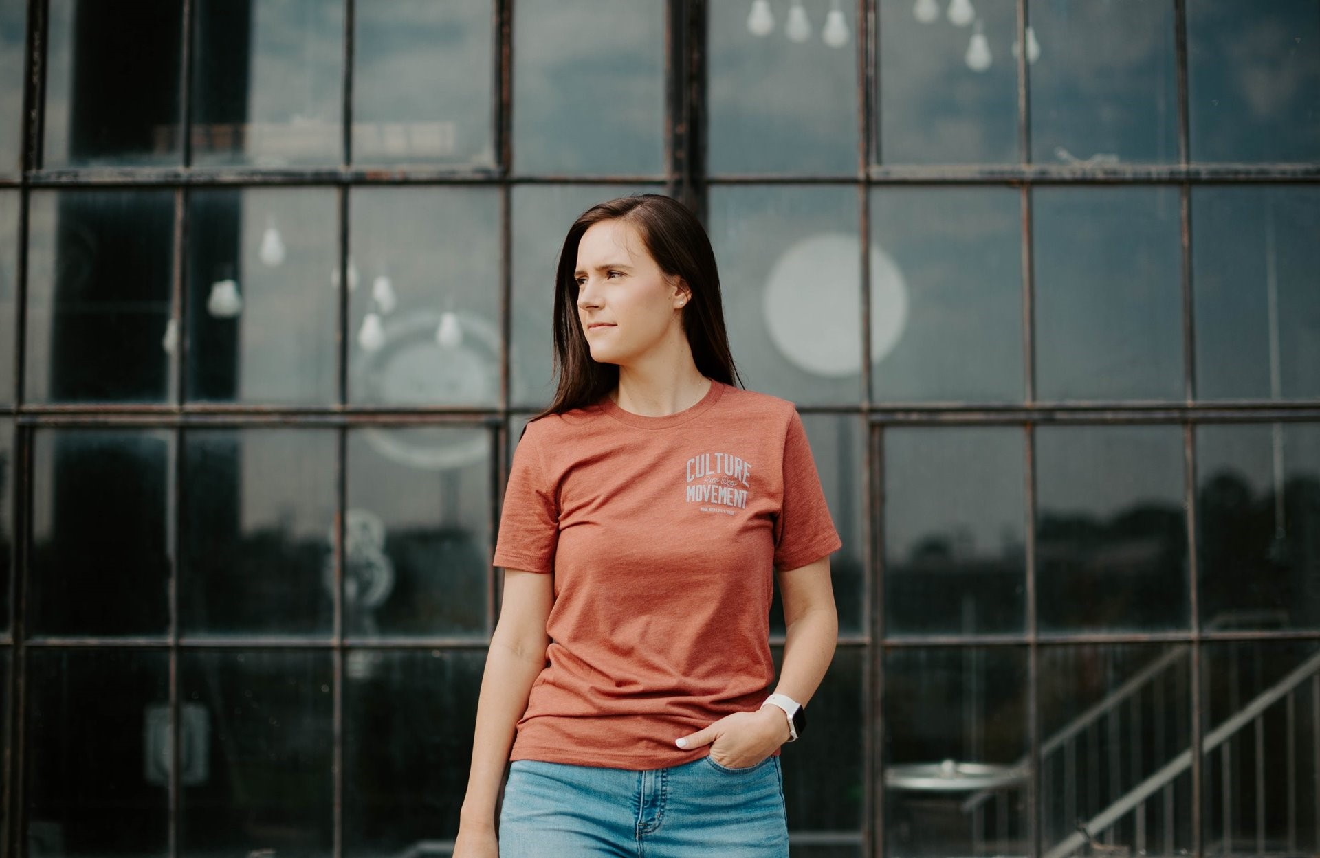 A woman standing in font of a building