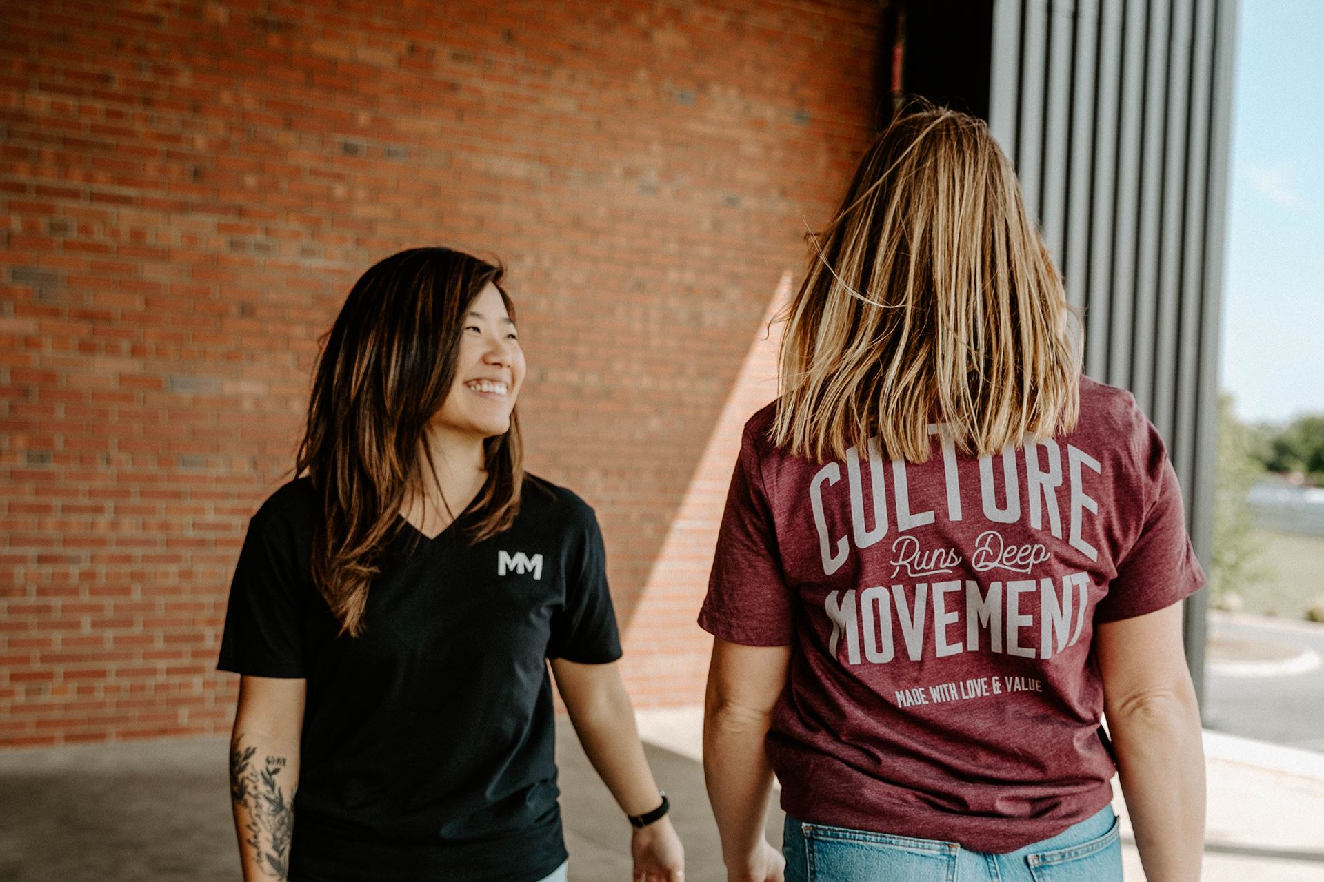 Two women modeling movement t-shirt