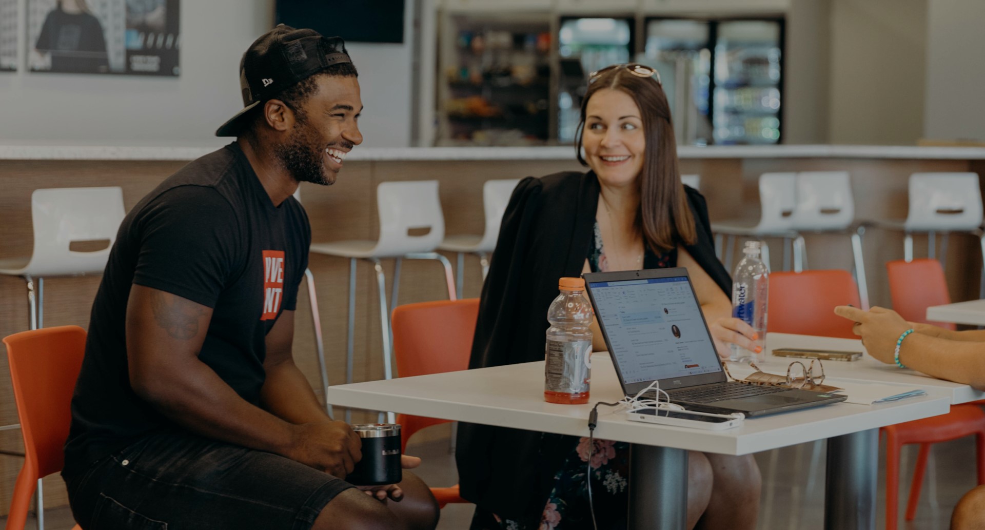 Two people sitting at a table smiling