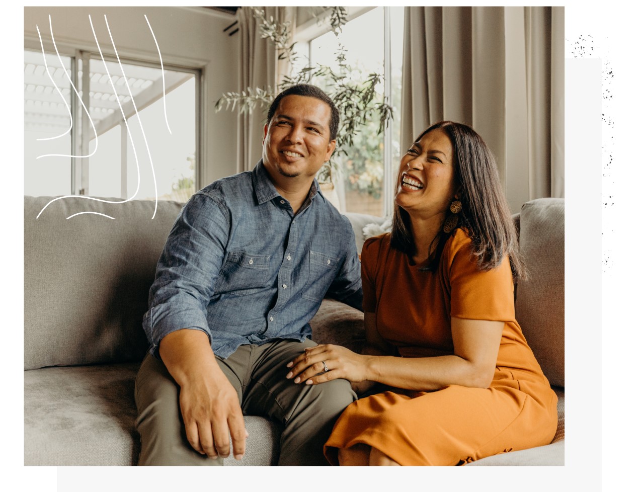 A seated couple laughing together