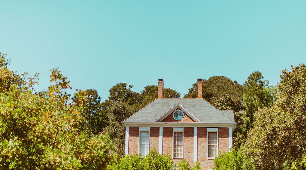 Brick house surrounded by trees