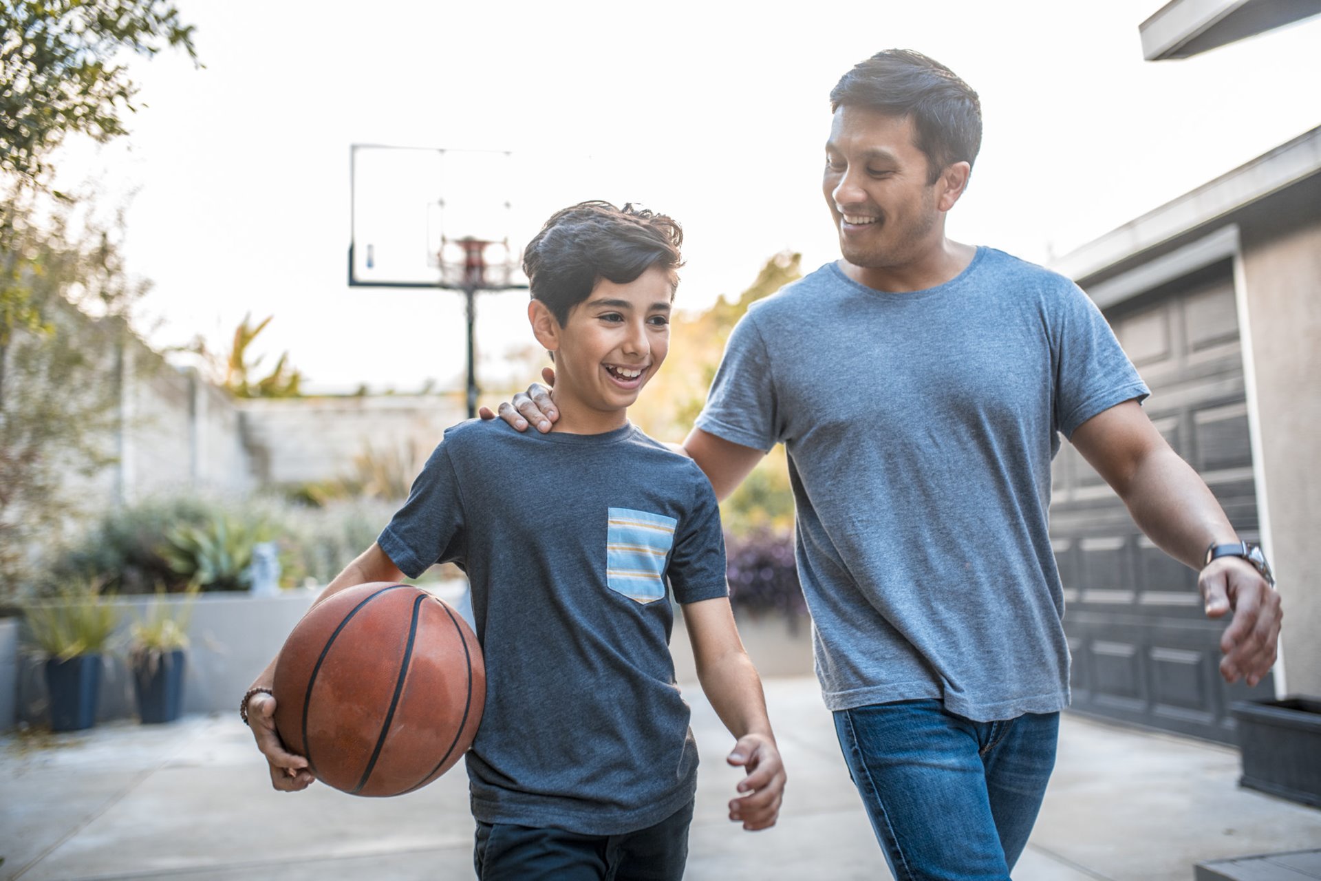 Father and son after the basketball match on back yard