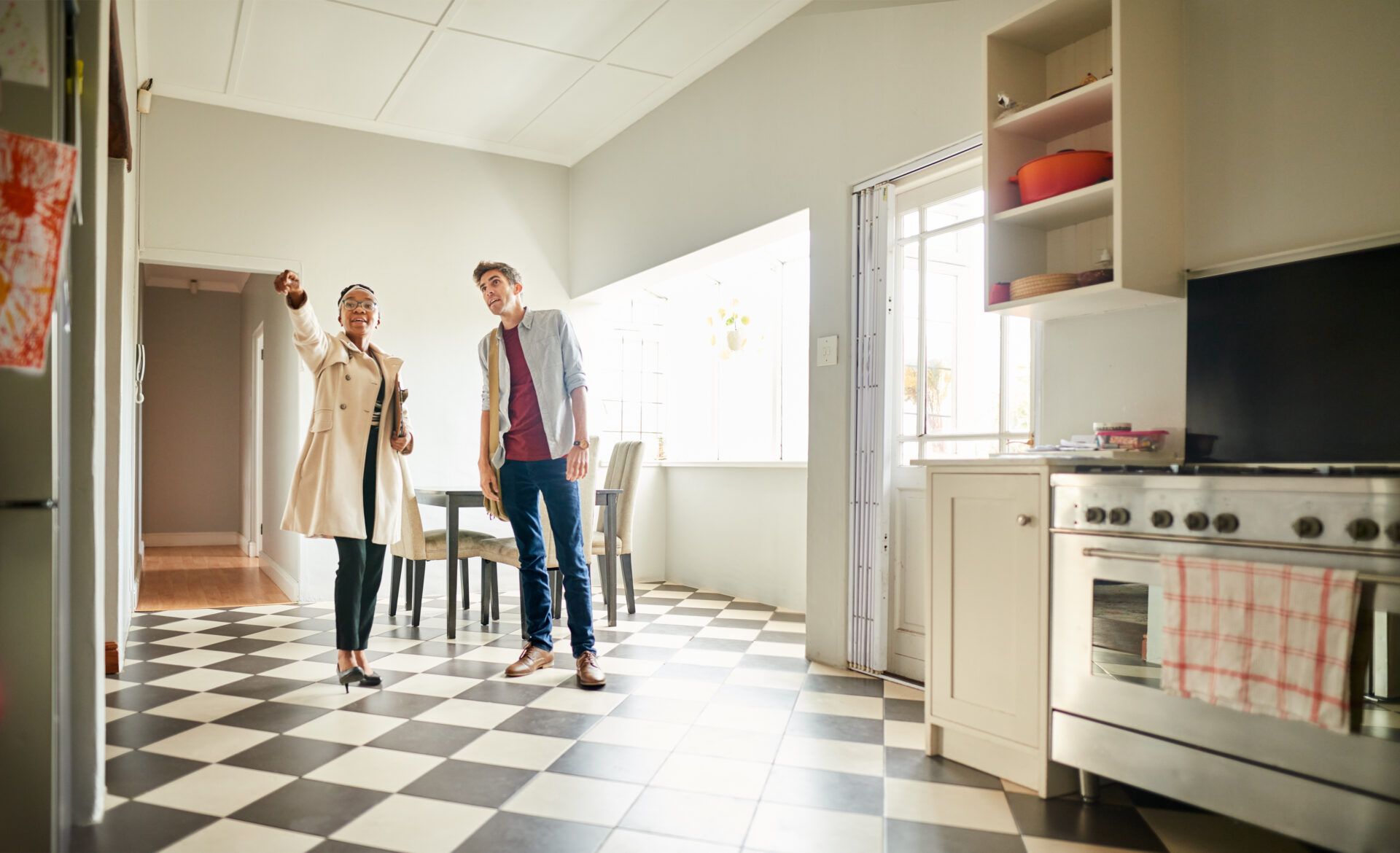 Real Estate Agent talking with a client in the kitchen of a house for sale