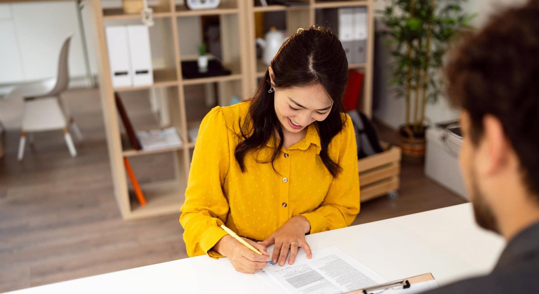 Young asian woman in yellow shirt