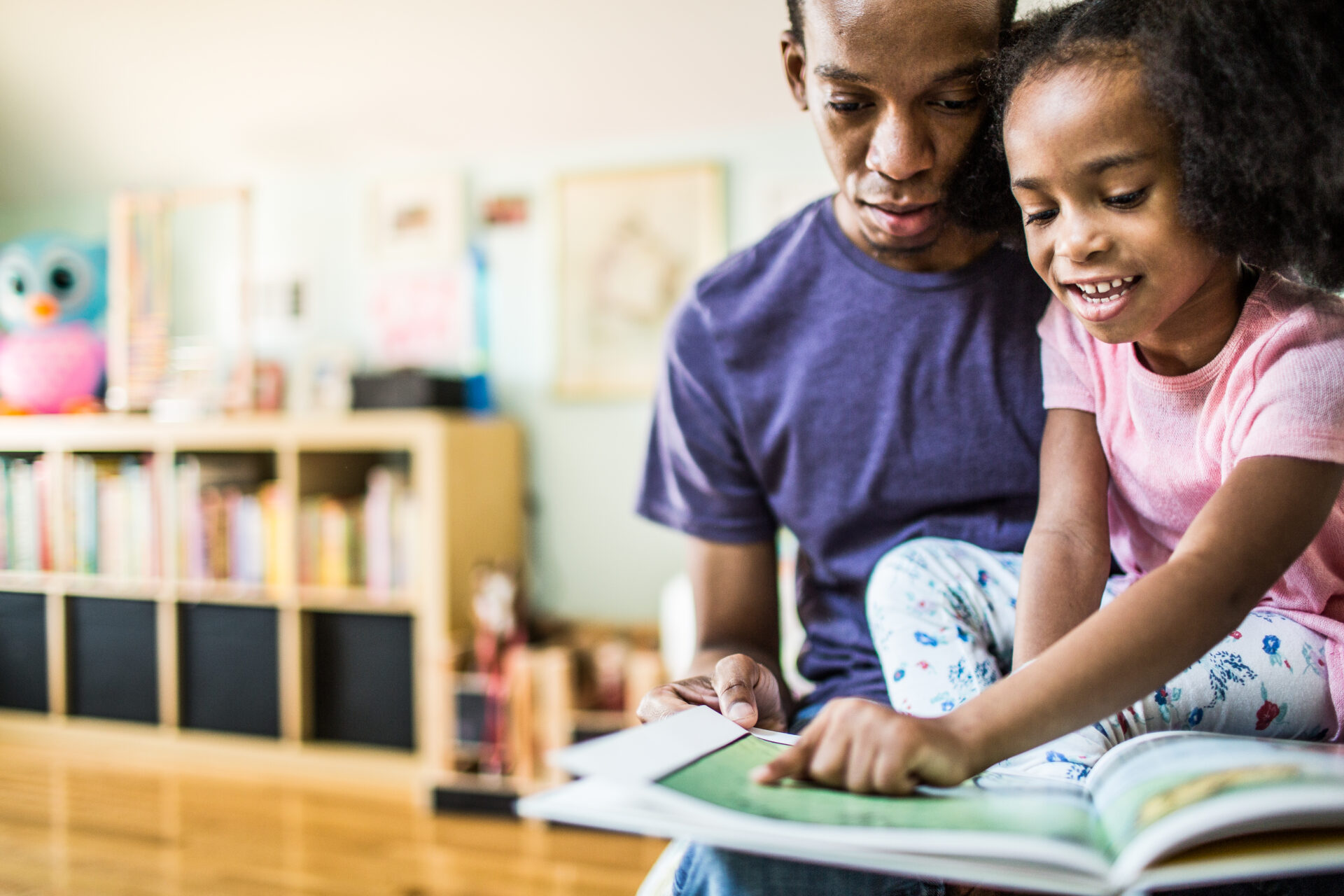 father and daughter reading at home