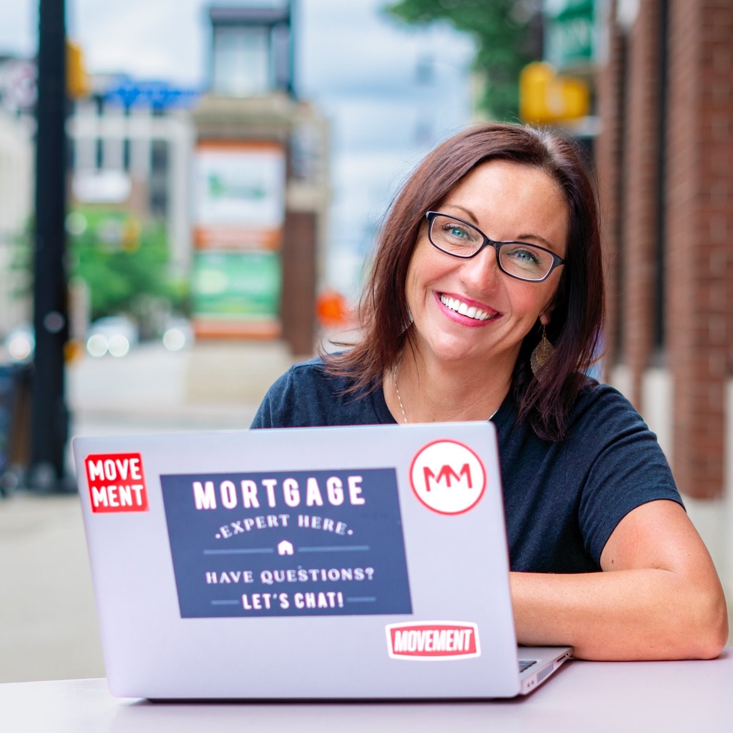 Portrait of woman in front of laptop