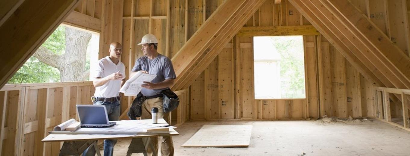 Two construction men inside a new home