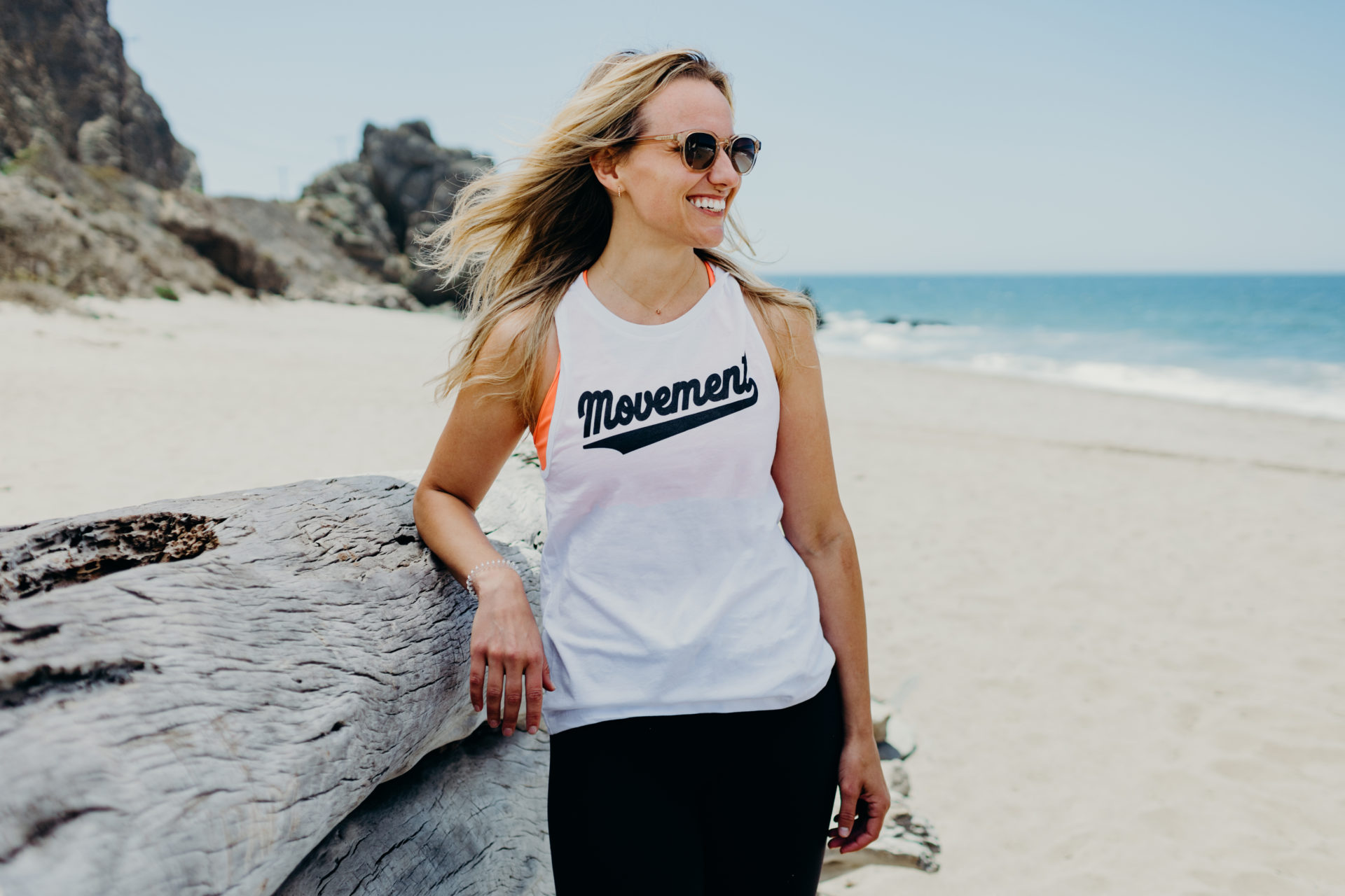 Women at the beach wearing sunglasses 