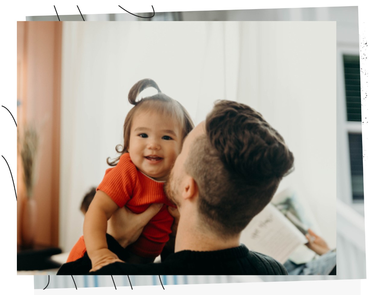 Father holding and kissing a baby on the cheek