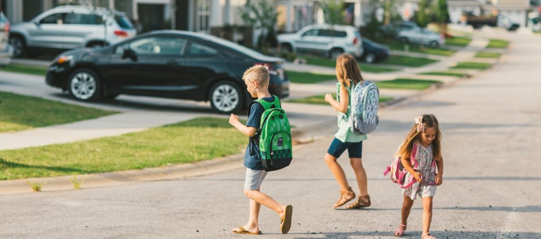 3 kids on the streets with their bookbags